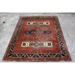 Turkish Red Ground Wool Rug with stylised pattern, 191cms x 152cms