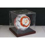 A cased signed Swindon Town football Club ball.