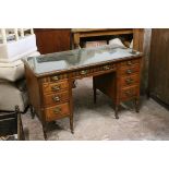 Victorian Oak Writing Desk with green leather inset top over an arrangement of nine drawers, with