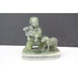 A vintage carved green agate figure in the form of a boy with sheep.