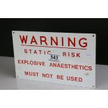 A metal warning sign static risk Explosive Anaesthtics must not be used.