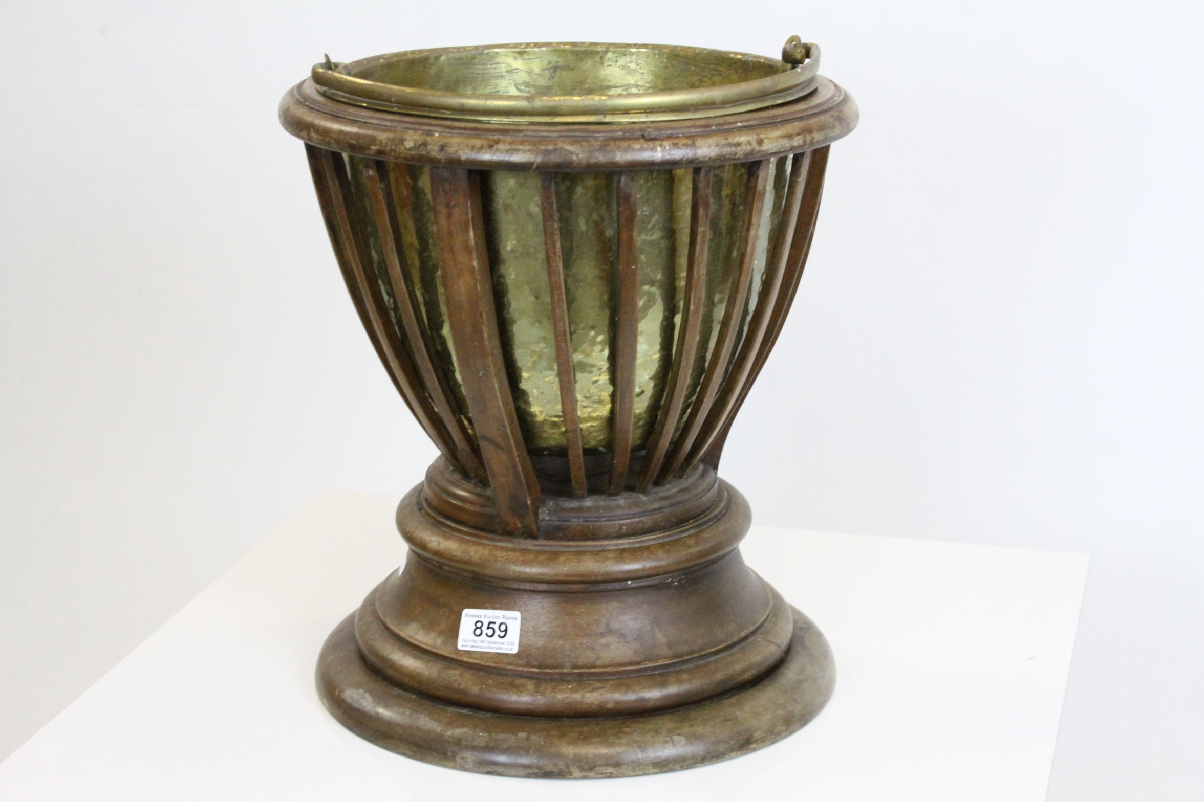 Early 20th century Plant Holder, the slatted sides holding a brass liner, the liner lifting to