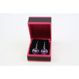 A pair of silver and heart shaped amethyst drop earrings.