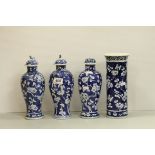 Three Chinese Apple blossom blue and white lidded vases together with one other of cylidrical