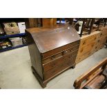 George III Oak Bureau, the drop front writing surface opening to reveal a fitted interior, over