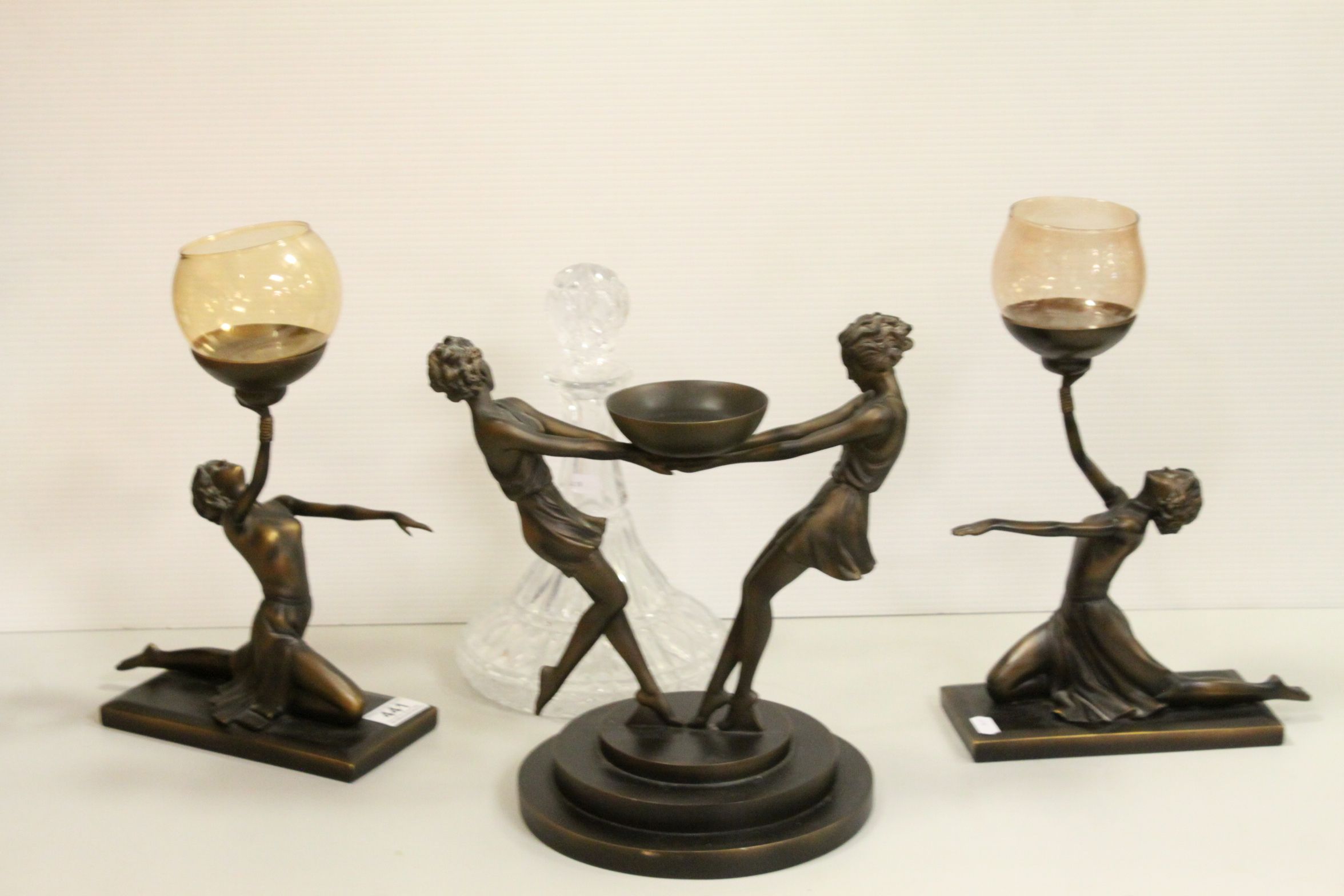 A trio of Art Deco style resin candle stands in the form of ladies together with a cut glass