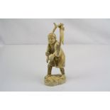 Japanese carved ivory figure of a farmer carrying vegetables on a stick , signed within a red