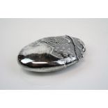 A silver plated vesta case in the form of a hatching bird.
