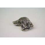 A silver dog brooch with ruby eye and marcasite's.