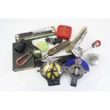 Box of mixed collectables to include vintage hair clippers, car badges and a harmonica.