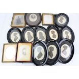 A collection of antique photographs and framed silhouettes.