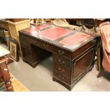 Mahogany Effect Twin Pedestal Desk with red leather inset top and an arrangement of nine drawers,