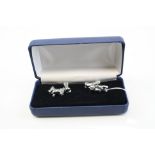 A pair of silver dog and bone cufflinks.