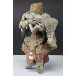 Tibetan Polychrome Painted Wooden Carved Figure of a Monster carrying a Girl in it's mouth, 34cms