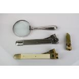 Silver Handled Magnifying Glass together with Three Cigar Cutters