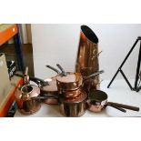 A group of antique copper pans, similar scuttle etc.