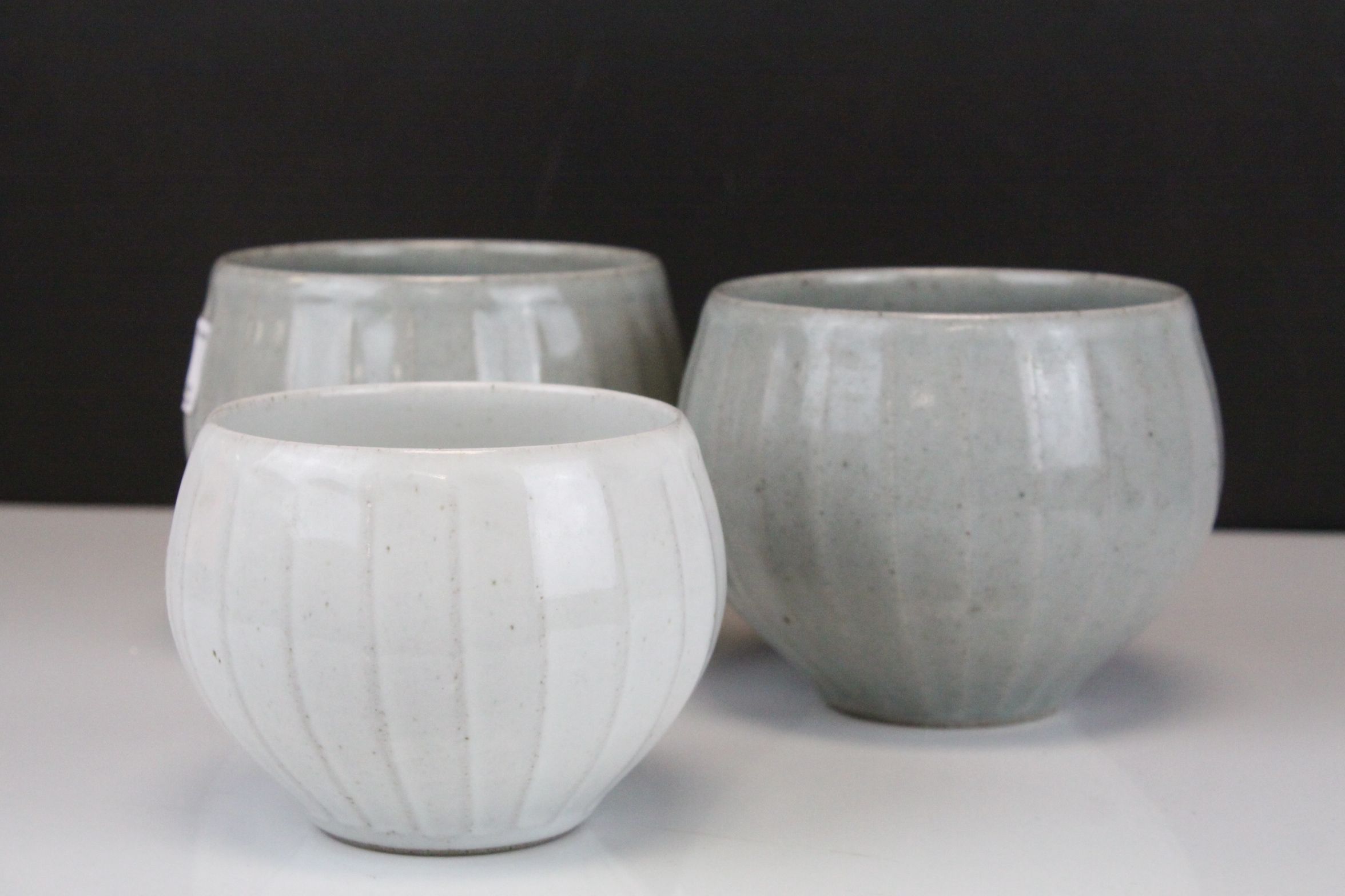 Three Studio Pottery Ribbed Bowls with A mark. largest 11.5cms high