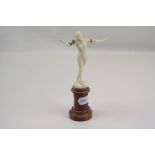 An Art Deco ivory figurine on a agate pedestal base signed G M Souilland.