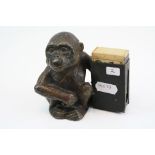 An early 20th century cold painted spelter match holder in the form of a monkey.