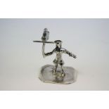 A silver figure of yeoman with a bird figure.