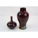 A 20th century art pottery flambe and iridescent balluster vase by Bernard Moore together with a