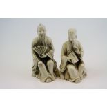 Two composite seated figures, one holding a fan , the other a bamboo drum, the tallest 8.5 cm (2)