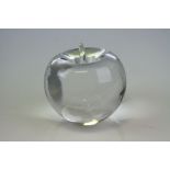 A glass paperweight in the form of an apple marked Tiffany & Co to the base.