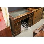 Victorian Mahogany Twin Pedestal Writing Desk with Green Leather Inset Top and an arrangement of