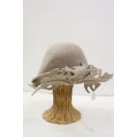Elvis Pampilio, beige asymetric felt hat with felt leaf design, together with hat stand. Pamipilio