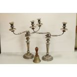 A pair of 19th century plated candlestick with three branch inserts together with a hand bell.