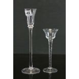 Two long stemmed glasses one with twisted stem.