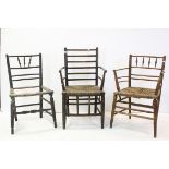In the manner of Morris & Co, Two Sussex Type Elbow Chairs with Rush Seats together with a further