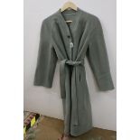 Couture pale sage green wool coat, button fastening with belt, rounded neckline and shoulders,