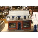 Dolls House in the form of a Antique Shop with contents to include taxidermy pike, paintings