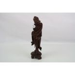 A Japanese carved wooden figure.