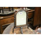 Small 19th century Swing Mirror held on an Iron Base, 30cms high