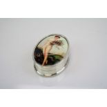 A silver and nude enamel paneled pill box.