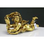 Ceramic Gilt recumbent Cherub Figure in leaf.