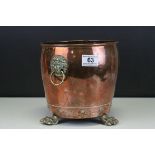 Antique Copper Jardiniere with Lion Mask Handles and raised on three brass paw feet