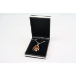 A silver and amber style pendant necklace cased.