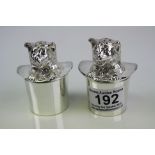 A pair of silver plated cat in the hat condiments.