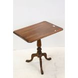 Georgian Mahogany Rectangular Tilt Top Table raised on turned pedestal support with three splay