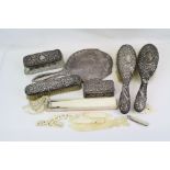 A collection of hallmarked sterling silver vanity items to include a brush, mirror and dressing