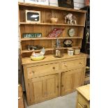 19th century Pine Dresser, the top with three shelves over two drawers and two cupboards, 157cms