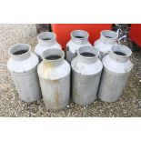 Seven vintage aluminium milk churns no lids.