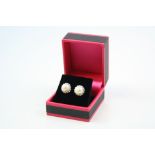 A pair of silver and pearl stud earrings