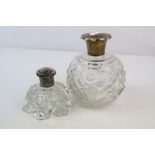 Two vintage cut glass scent bottles to include one with a fully hallmarked sterling silver lid.