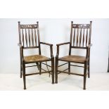 Pair of Early 20th century Art Nouveau Oak Elbow Chairs with pierced carved top rails and turned