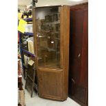 Ercol Stained Elm Corner Display Cabinet, the glazed upper door enclosing two glass shelves, above a