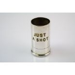 A novelty silver plated shot measure in the form of a shotgun cartridge engraved JUST A SHOT.